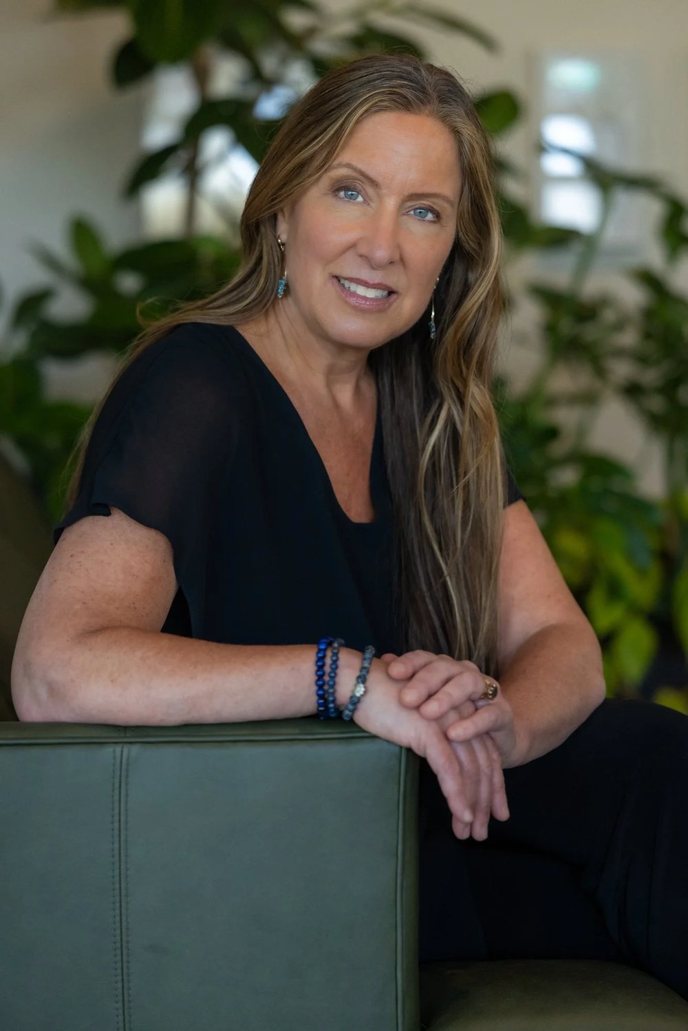 Lisa Watson seated in a green chair