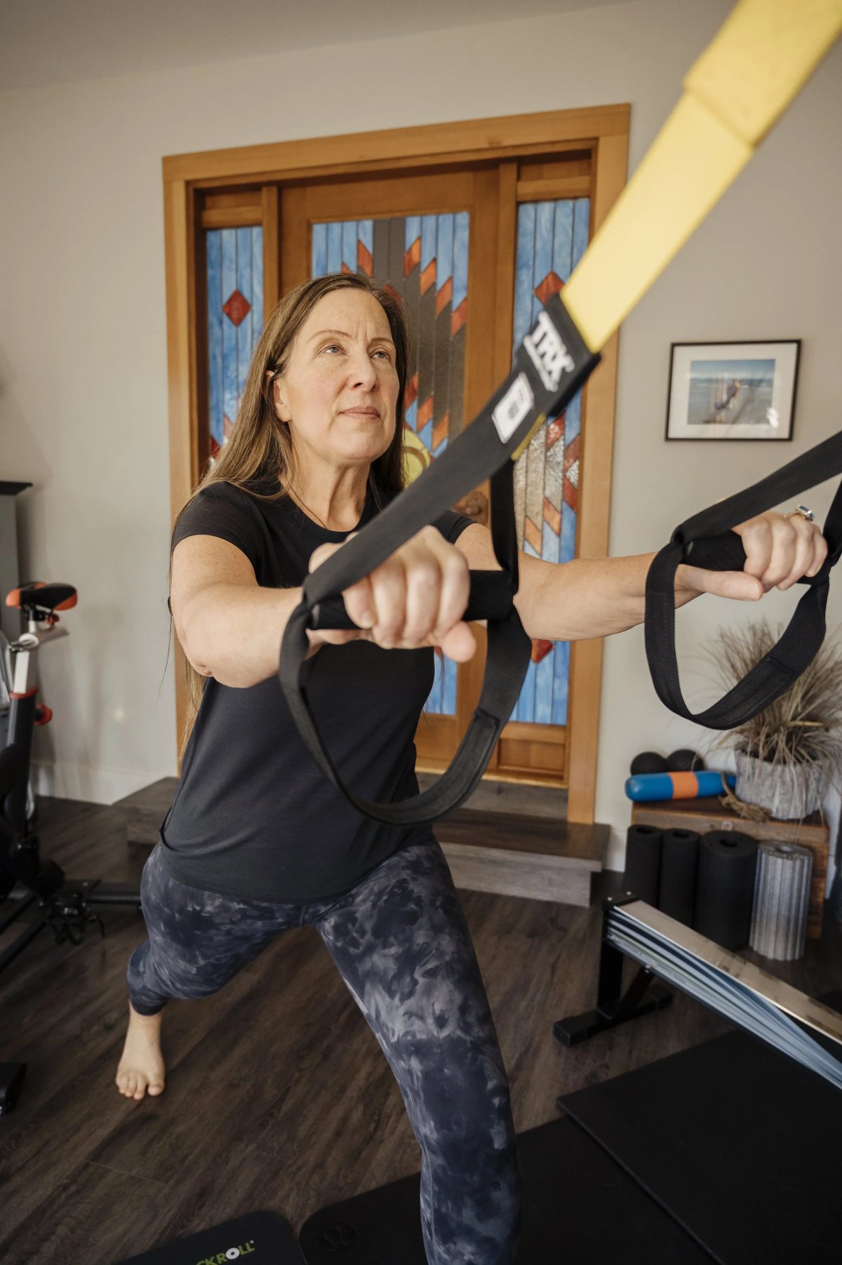 Lisa exercising with suspension training equipment