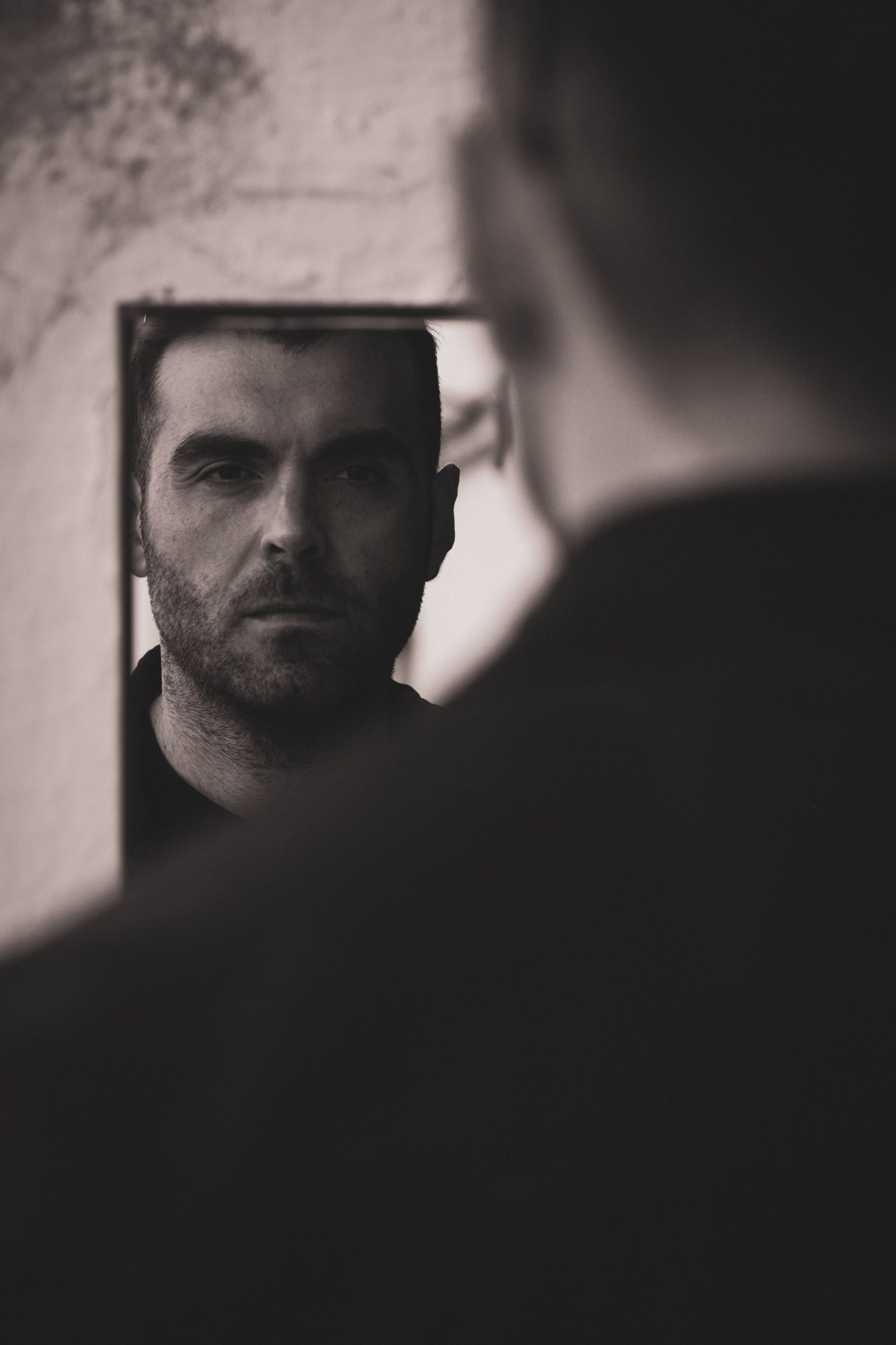 A man meeting his own gaze in a mirror