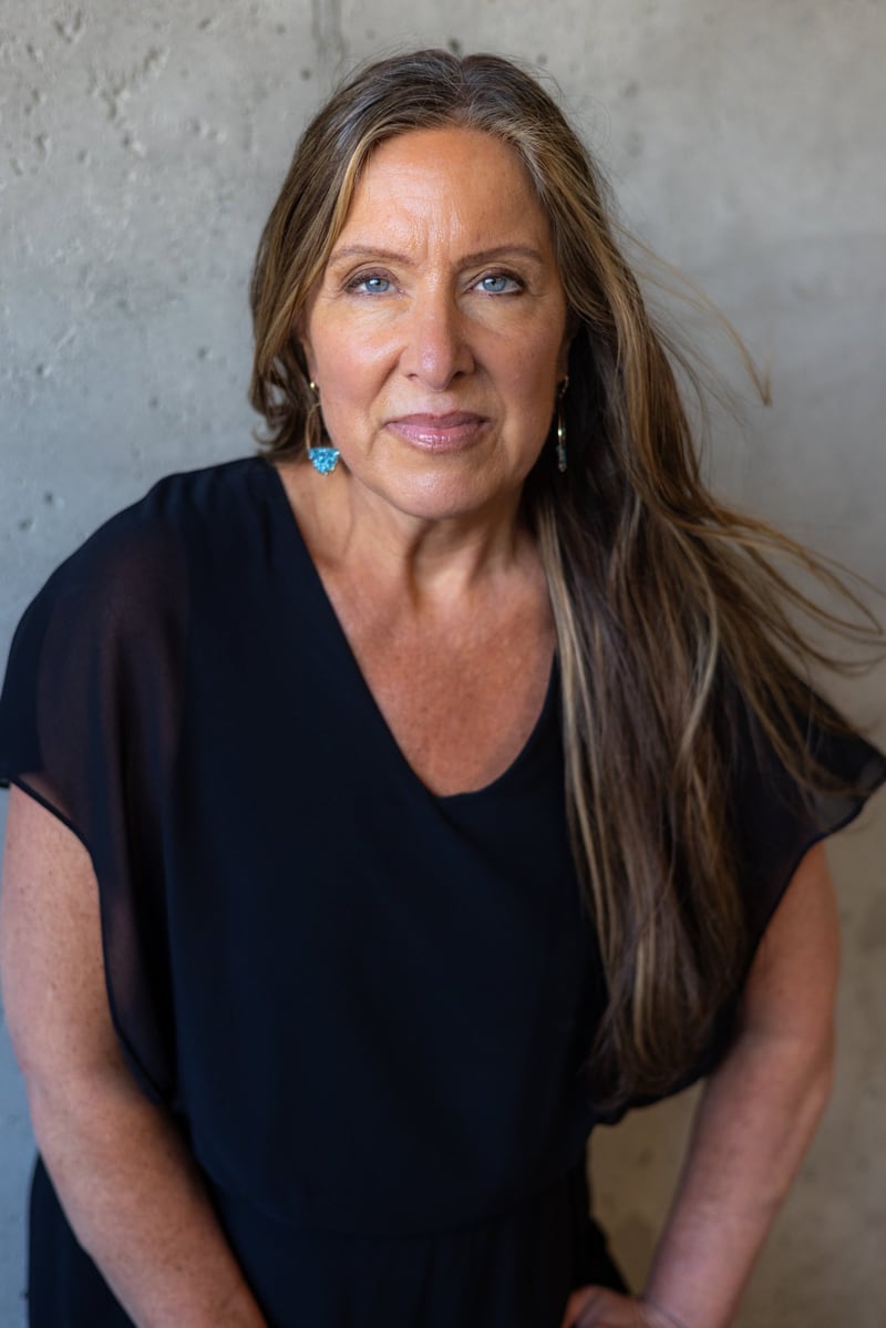 Lisa Watson in a black top against a concrete wall