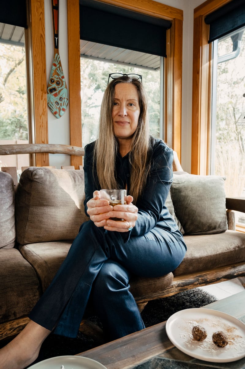 Lisa Watson seated at home with a cup of tea
