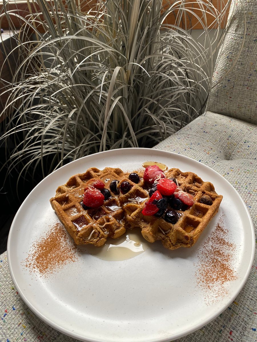 Paleo and vegan waffles topped with berries